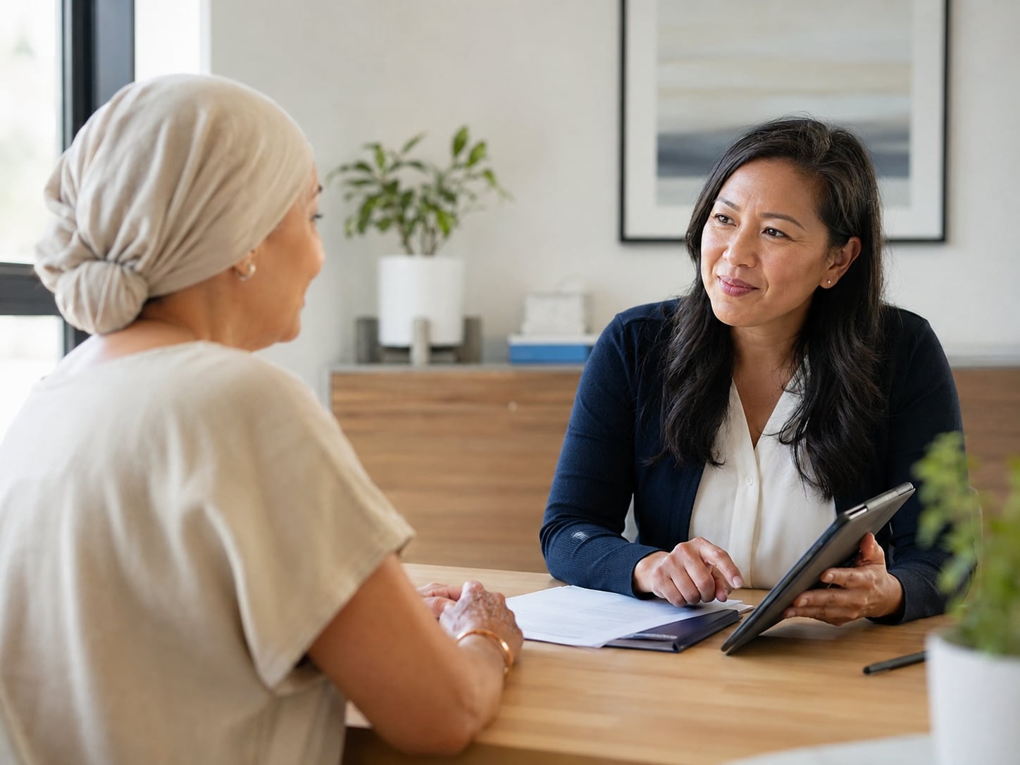 A navigator shares up-to-date guidance on a tablet with a patient