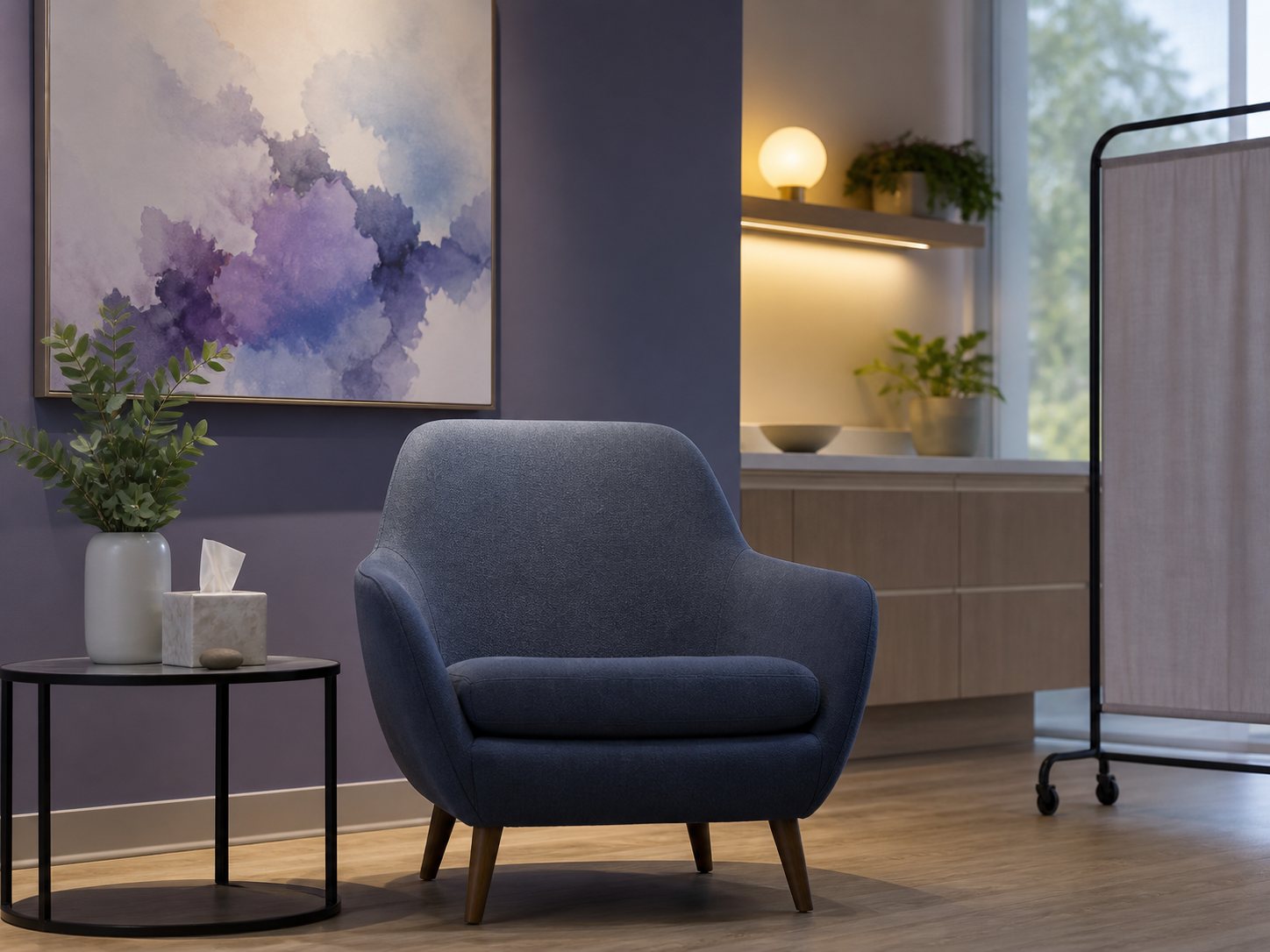 An empty upholstered chair under warm lighting beside framed abstract art.